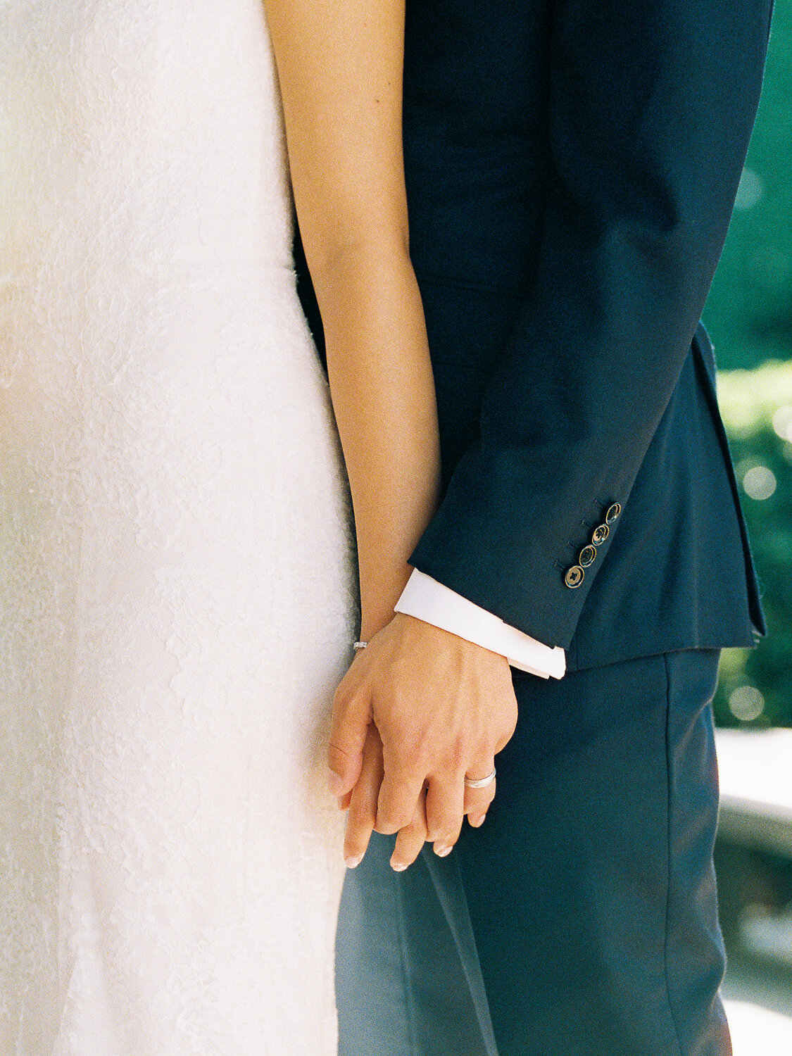 bride-and-groom-holding-hands-detail