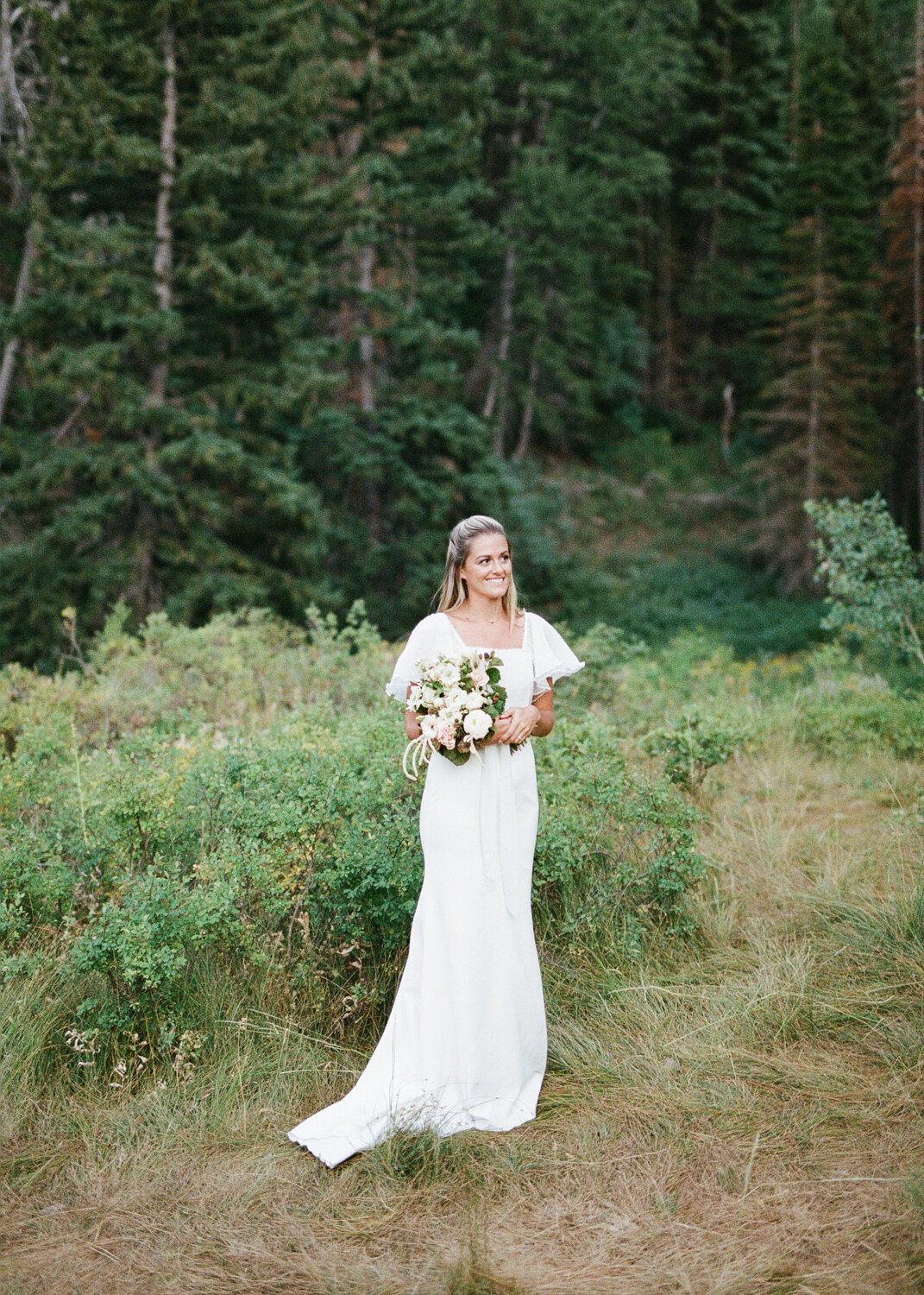 bride smiling in mountains
